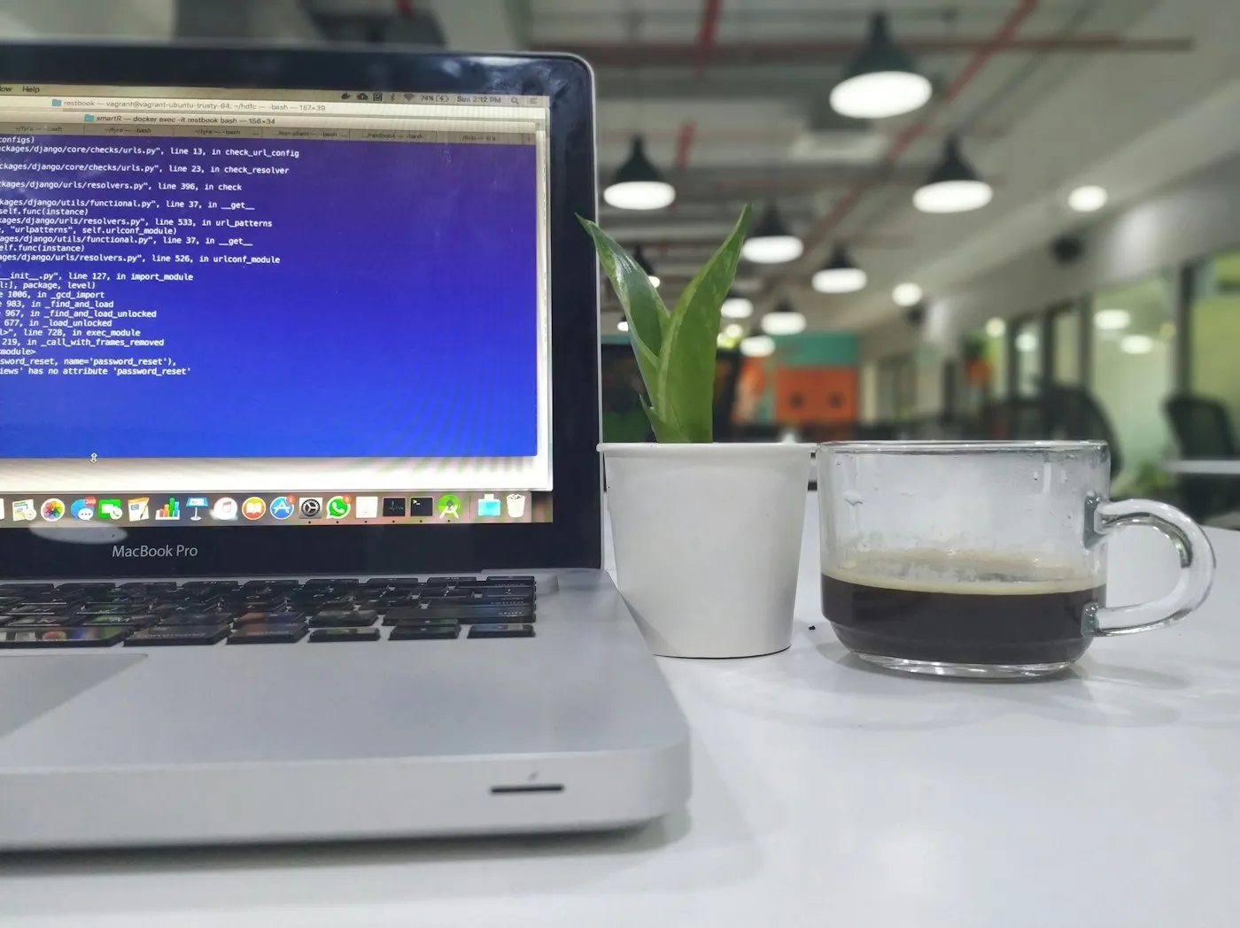 A laptop open on a desk in a technology workplace